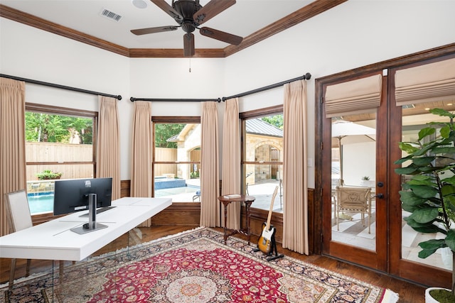 office area with ornamental molding, visible vents, dark wood finished floors, and a ceiling fan