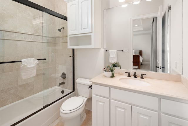 full bathroom featuring combined bath / shower with glass door, vanity, toilet, and tile patterned flooring