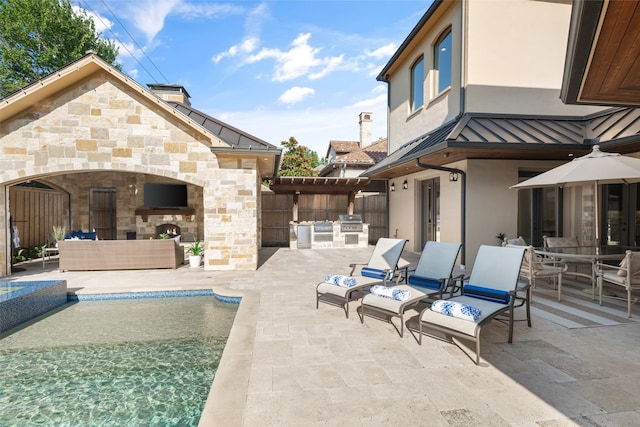 view of swimming pool with ceiling fan, an outdoor living space with a fireplace, and a patio