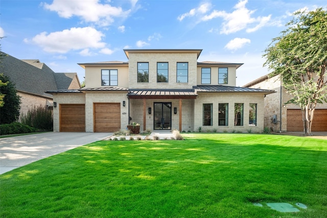 modern home featuring metal roof, concrete driveway, a front lawn, and a standing seam roof