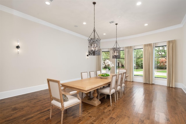 dining area featuring baseboards, dark wood finished floors, visible vents, and crown molding