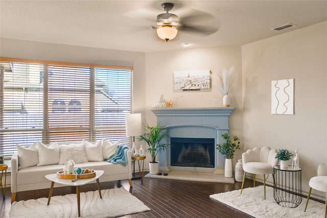 living room with ceiling fan and dark hardwood / wood-style floors