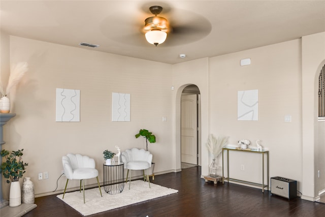 sitting room featuring ceiling fan and dark hardwood / wood-style floors