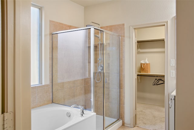 bathroom featuring shower with separate bathtub