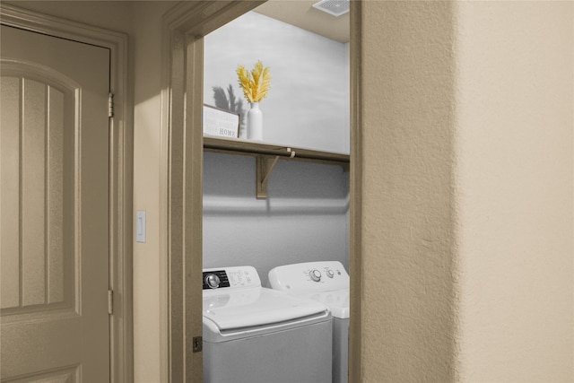 laundry area featuring washing machine and clothes dryer