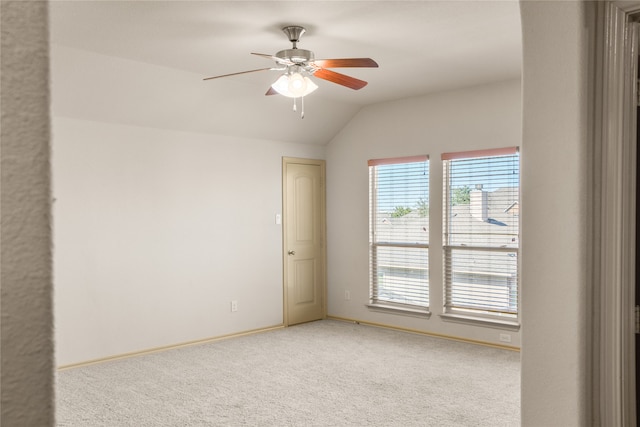 spare room featuring ceiling fan, carpet flooring, and lofted ceiling