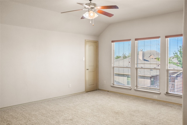 empty room featuring lofted ceiling, ceiling fan, and carpet floors