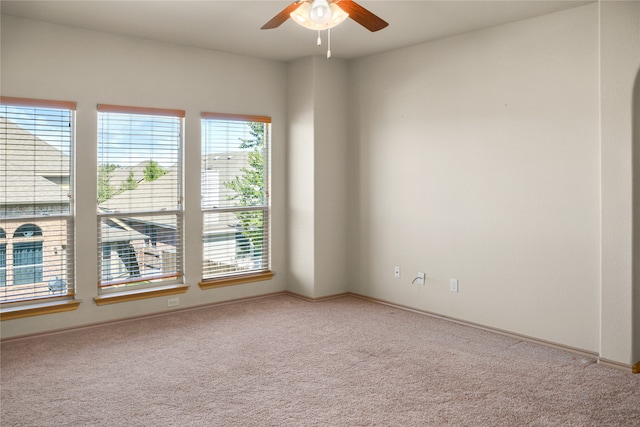 carpeted spare room with ceiling fan