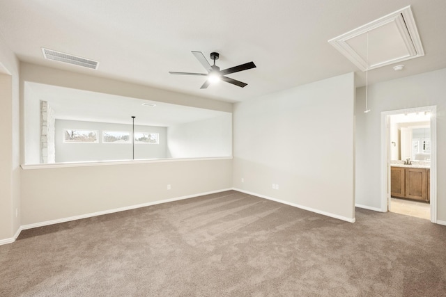 unfurnished room featuring ceiling fan, carpet flooring, and sink