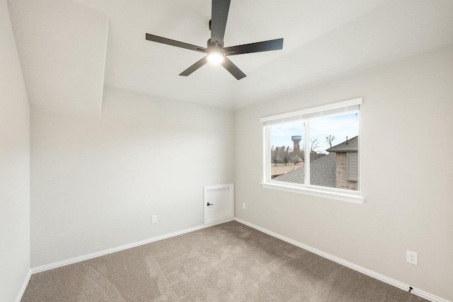 carpeted spare room with ceiling fan