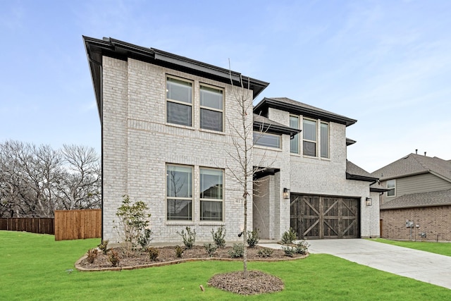 view of front of property with a garage and a front lawn