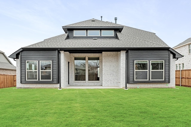 rear view of house with a yard