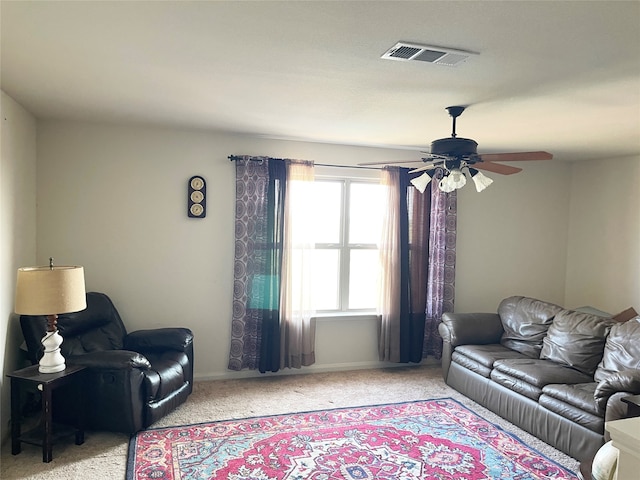 carpeted living room with ceiling fan