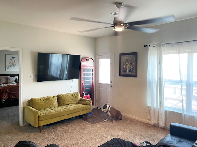 living room featuring carpet flooring and ceiling fan