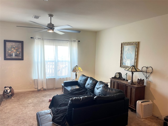 carpeted living room with ceiling fan