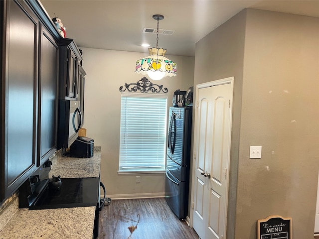 kitchen with plenty of natural light, dark hardwood / wood-style flooring, and hanging light fixtures