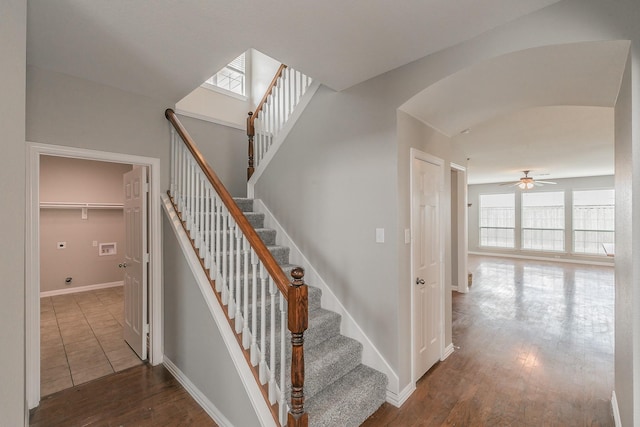 stairs with hardwood / wood-style flooring and ceiling fan