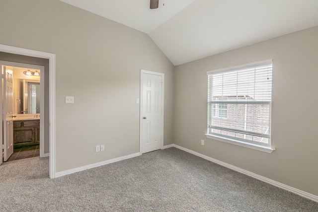 unfurnished bedroom featuring lofted ceiling, ceiling fan, and carpet