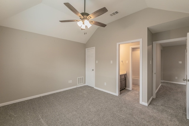 unfurnished bedroom featuring carpet, ensuite bathroom, high vaulted ceiling, and ceiling fan