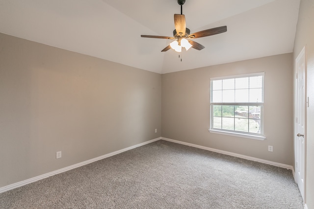 carpeted spare room with ceiling fan and lofted ceiling