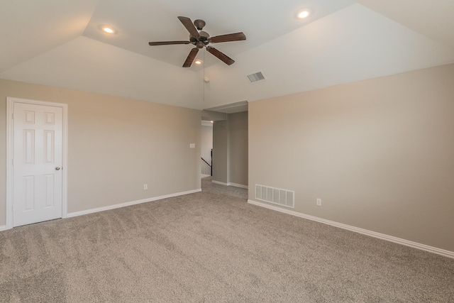 carpeted spare room with vaulted ceiling and ceiling fan