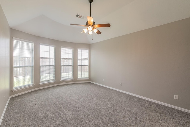 carpeted empty room featuring a wealth of natural light and ceiling fan