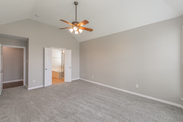 unfurnished bedroom featuring light carpet, ensuite bath, ceiling fan, and high vaulted ceiling