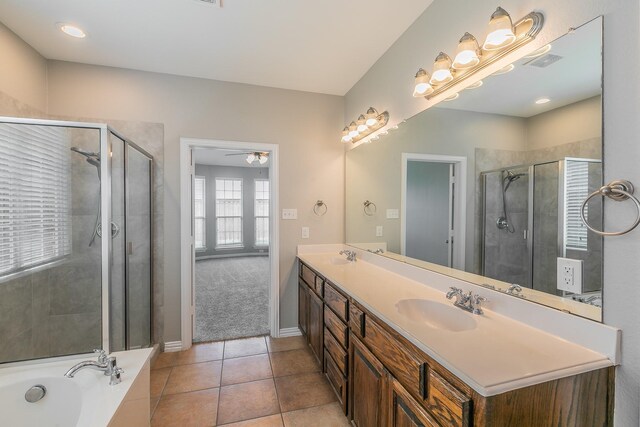 bathroom with tile patterned flooring, separate shower and tub, dual vanity, and ceiling fan