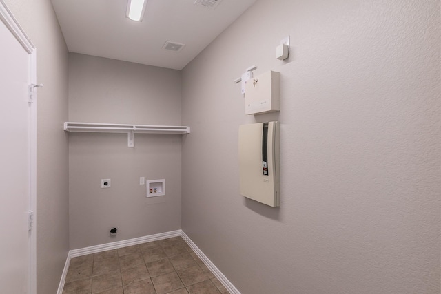 clothes washing area with tile patterned floors, washer hookup, and hookup for an electric dryer