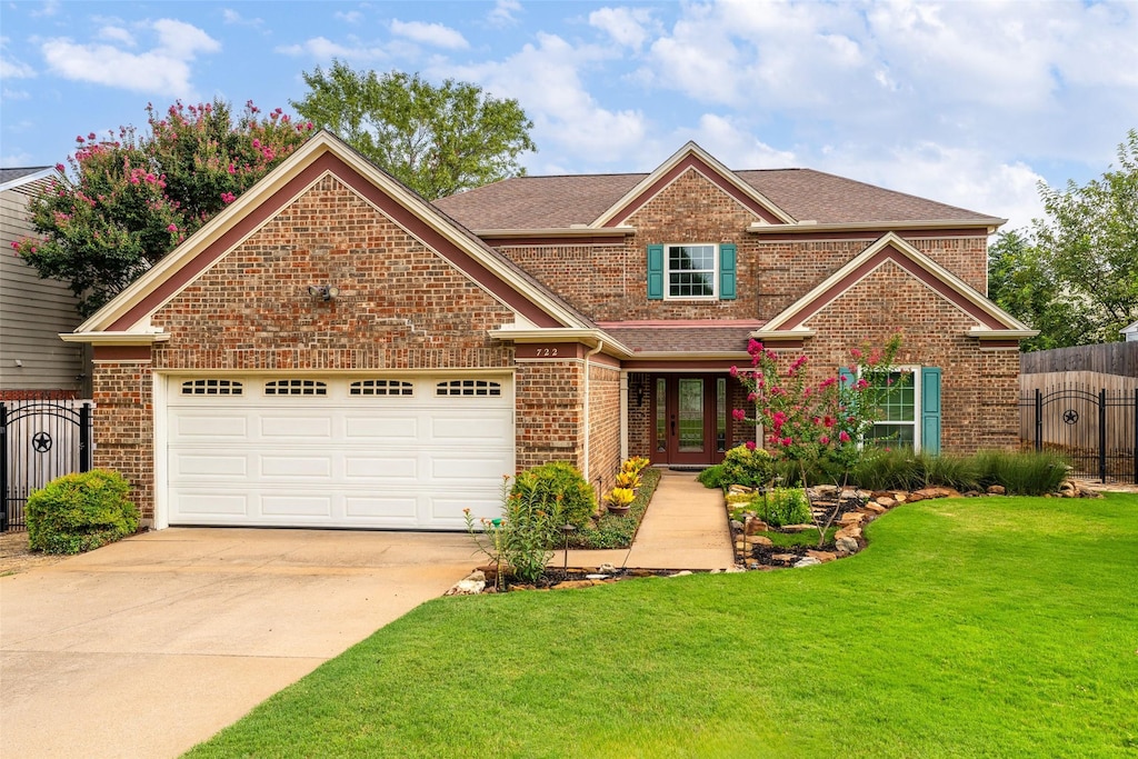 view of front of house featuring a garage and a front yard