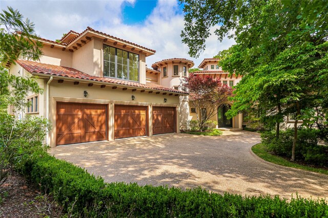 mediterranean / spanish-style home featuring a garage