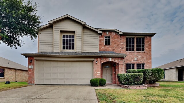 view of front of house featuring a garage and a front yard