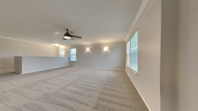 carpeted spare room featuring ornamental molding and ceiling fan