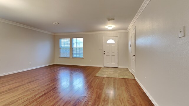 foyer entrance with crown molding and light hardwood / wood-style floors