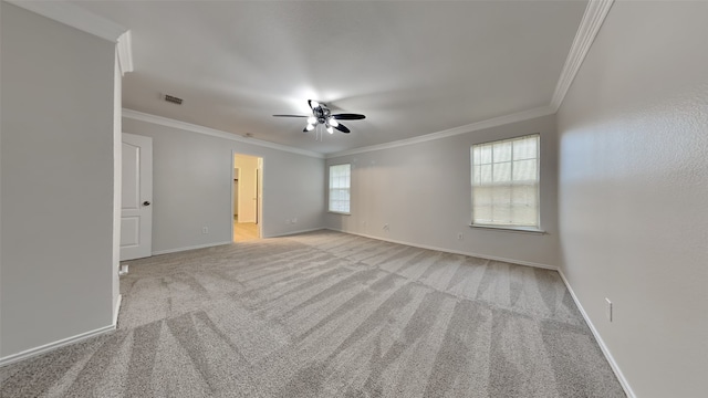 unfurnished room featuring light carpet, crown molding, and ceiling fan