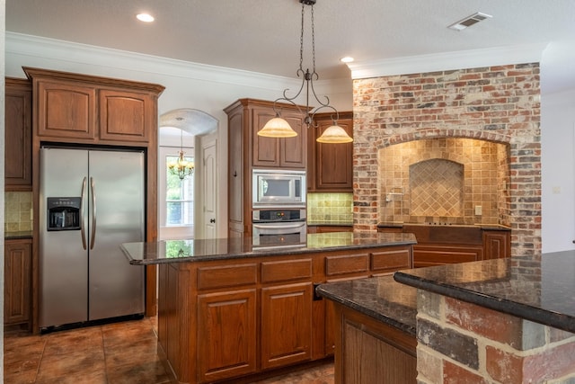 kitchen with stainless steel appliances, a center island, tasteful backsplash, and decorative light fixtures