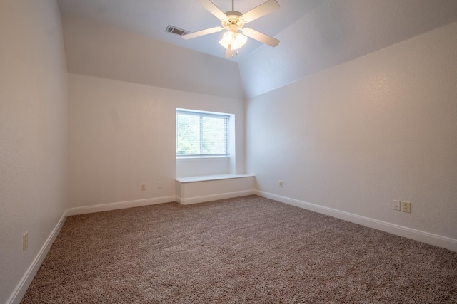 spare room featuring ceiling fan, vaulted ceiling, and carpet