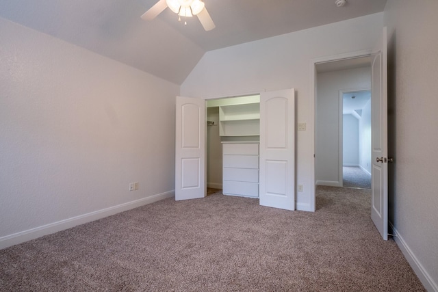 unfurnished bedroom with a closet, ceiling fan, carpet, and lofted ceiling