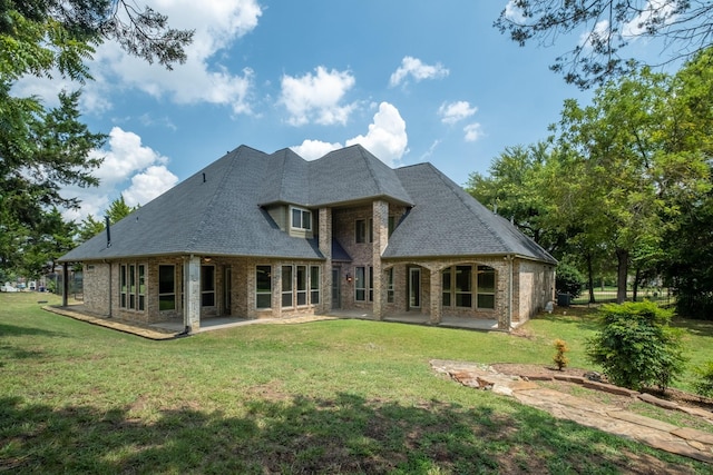 back of property featuring a patio area and a yard