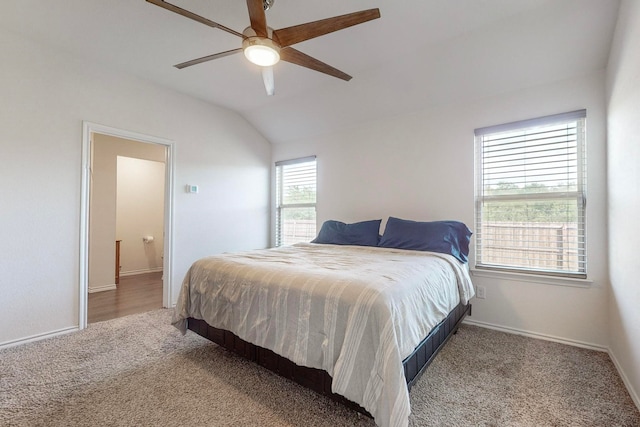 bedroom with ceiling fan, lofted ceiling, and light colored carpet