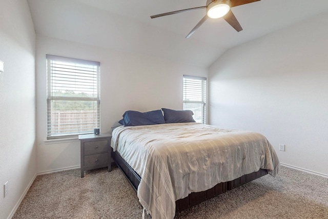 bedroom featuring light carpet, ensuite bathroom, ceiling fan, and vaulted ceiling