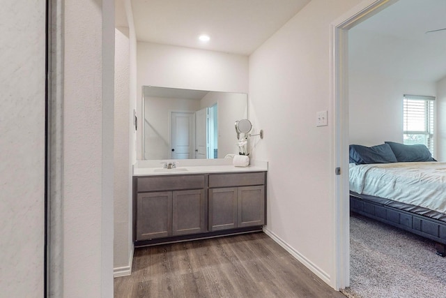 bathroom featuring vanity, a shower with door, toilet, and hardwood / wood-style floors