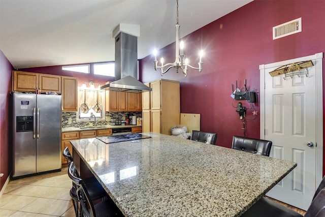 108 5th St, Whitney, TX 76692 - kitchen featuring stainless steel refrigerator with ice dispenser, island exhaust hood, a breakfast bar, a chandelier, and high vaulted ceiling