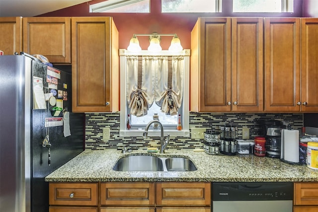 108 5th St, Whitney, TX 76692 - kitchen with appliances with stainless steel finishes, a sink, tasteful backsplash, and light stone countertops