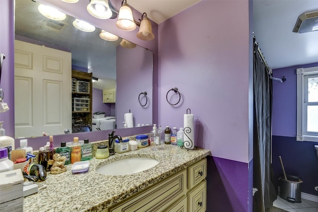 108 5th St, Whitney, TX 76692 - full bath with vanity, washing machine and dryer, tile patterned floors, a shower with shower curtain, and toilet