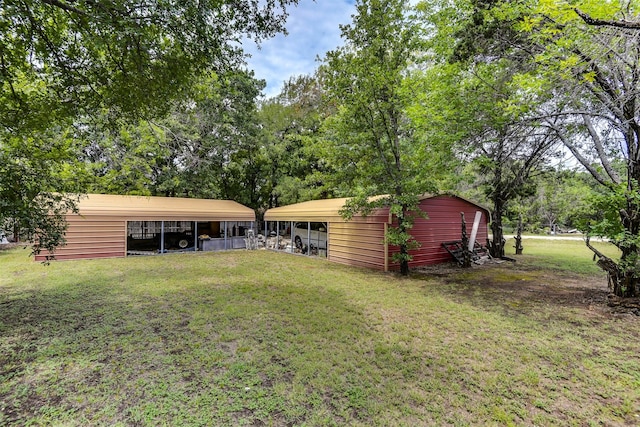 108 5th St, Whitney, TX 76692 - view of green lawn with a carport and an outbuilding