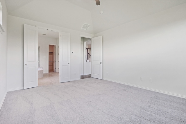 unfurnished bedroom with vaulted ceiling, ceiling fan, and light colored carpet