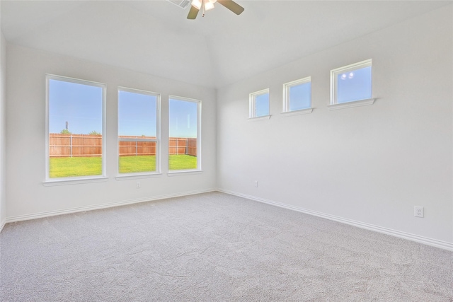 empty room featuring vaulted ceiling, ceiling fan, and carpet flooring