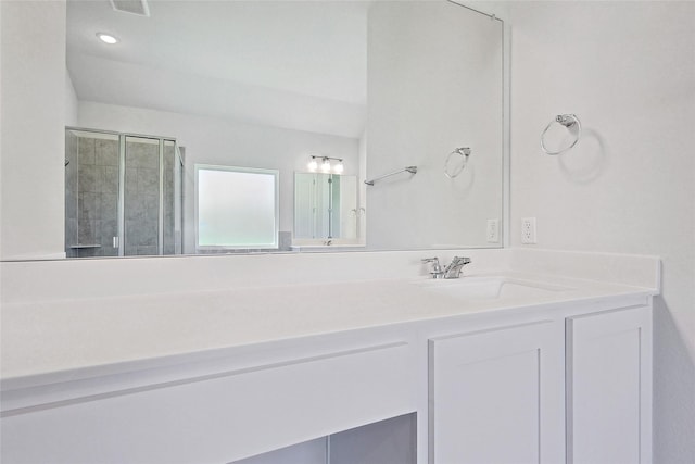 bathroom featuring vanity and an enclosed shower