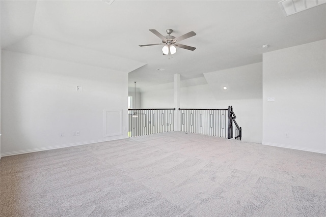 carpeted spare room with ceiling fan